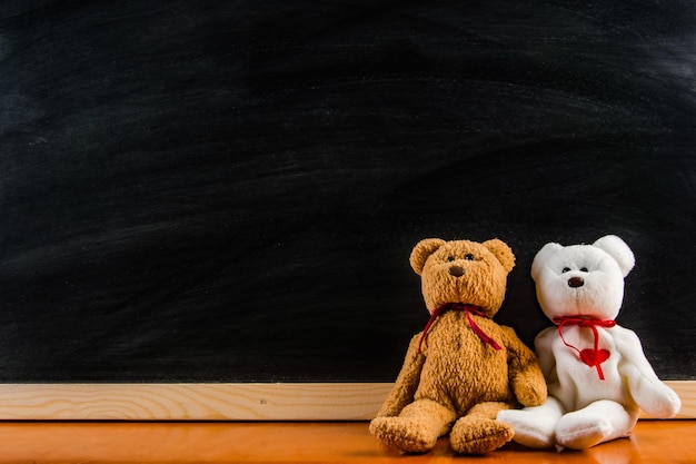 Teddy bear with blackboard background