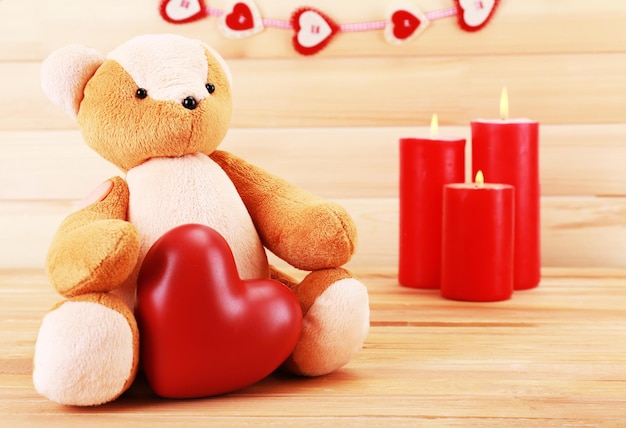 Teddy bear with heart and candles, love concept