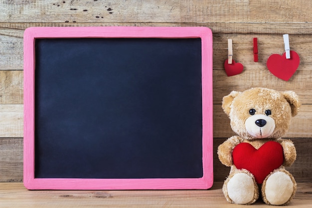 Teddy bear with heart sharp and black board