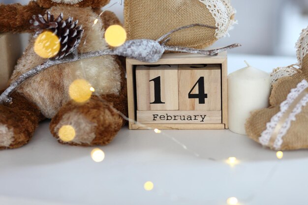 Teddy Bear with heart sitting on wood table Valentine's day and love concept