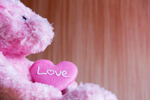 Teddy Bear with Heart on wood background, valentine