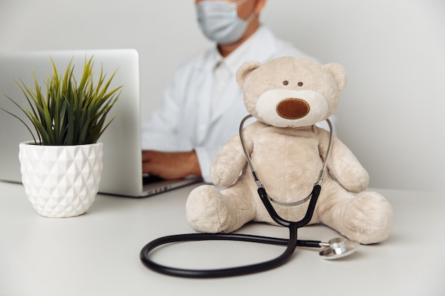 Teddy Bear with stethoscope in pediatrician office Child healtcare concept