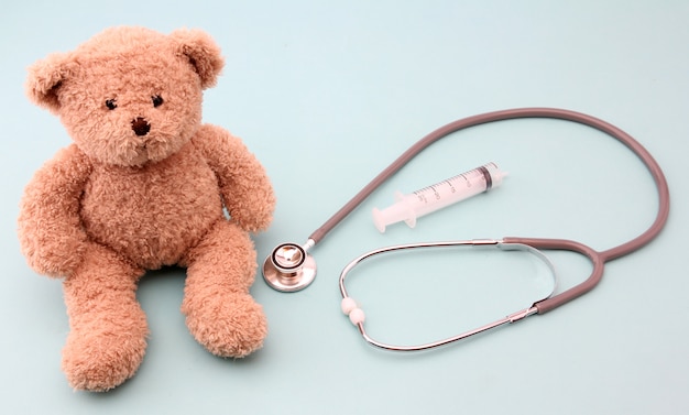 Teddy bears and medical equipment on blue