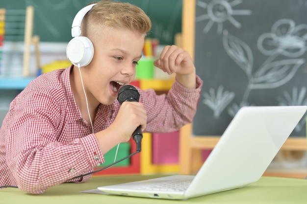 Teen boy in headphones singing karaoke