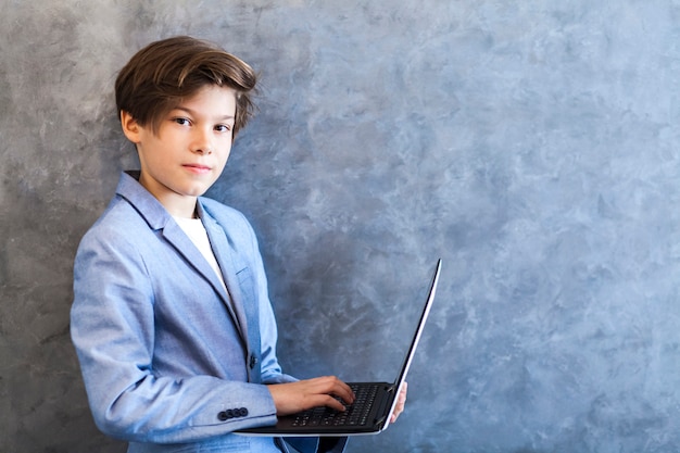 Teen boy holding laptop