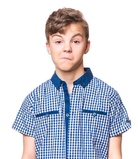 Teen boy making silly grimace funny surprised face Playful child isolated on white background Emotional portrait of caucasian teenager looking at camera