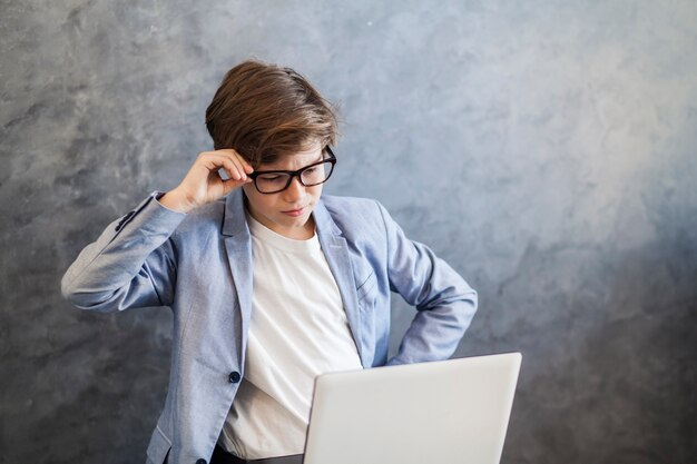 Teen boy working on laptop