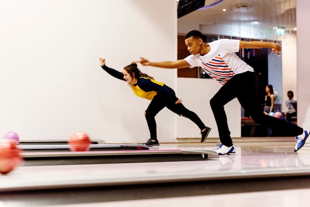 Teen boys bowling together