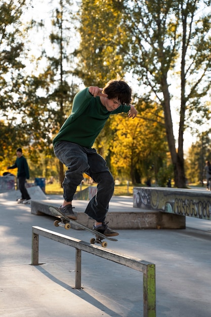 Teen doing tricks on skateboard full shot