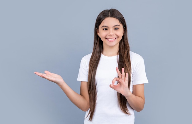 teen girl on background ok photo of teen girl with long hair wearing tshirt teen girl isolated on grey teen girl in studio