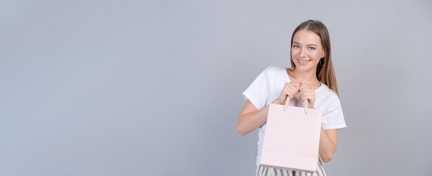 Teen girl doing shopping holding shopping bag in her hands fashion young woman