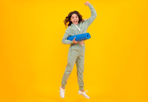 Teen girl dressed in sports uniform teenager in a posh stylish sports suit in a hoodie with a hood