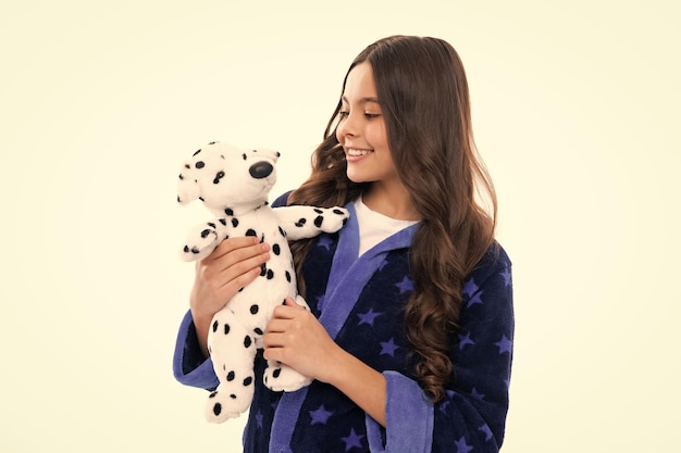 Teen girl feeling relaxed in pajamas good morning teenage girl\
embracing toy childhood toys and kids cute teen girl cuddling\
favorite fluffy toy happy girl face positive and smiling\
emotions