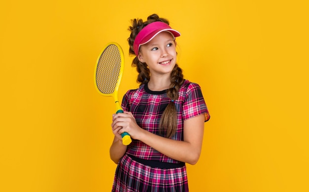 Teen girl in fitness cap holding tennis or badminton racket sport