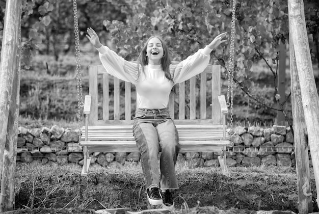 Teen girl having fun on playground childhood happiness relax in park summertime activity