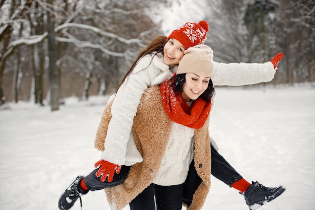 Teen girl and her mother having fun at winter park