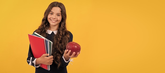 Teen girl hold apple after study healthy childhood happy kid going to do homework banner of schoolgirl student school child pupil portrait with copy space