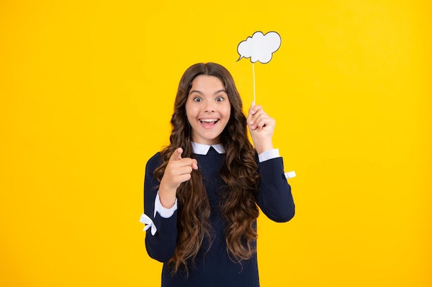 Photo teen girl holding clouds empty space thinking bubble comment cloud over yellow background