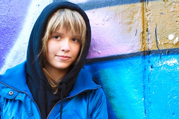 Teen girl in the hood on a city street.Street style of the youth.