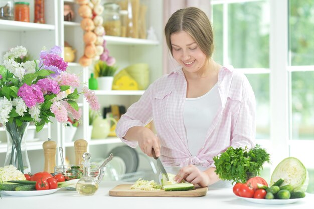 Teen girl preparing fresh salad