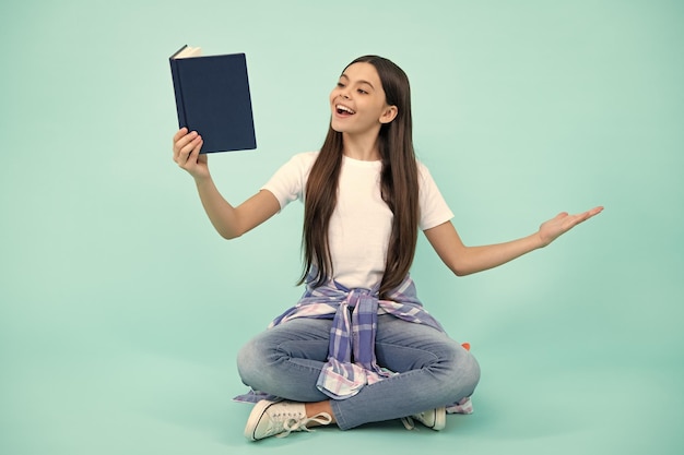 Teen girl pupil hold books notebooks isolated on blue background copy space Back to school teenage lifestyle education and knowledge Happy teenager positive and smiling schoolgirl