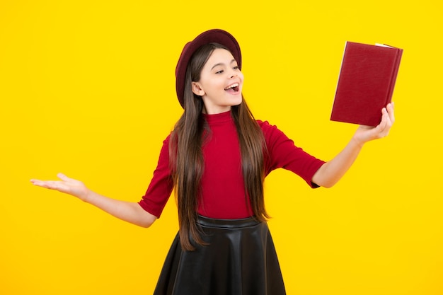 Teen girl pupil hold books notebooks isolated on yellow background copy space Back to school teenage lifestyle education and knowledge Excited teenager glad amazed and overjoyed emotions