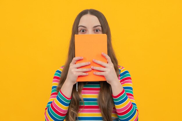 Teen girl pupil hold books notebooks isolated on yellow background copy space back to school teenage lifestyle education and knowledge