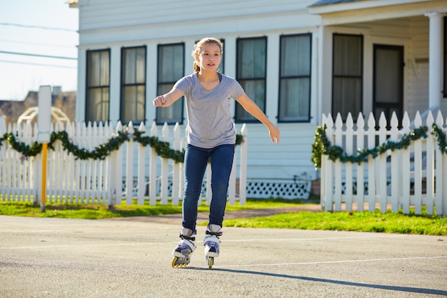 Teen girl rolling skate in the street