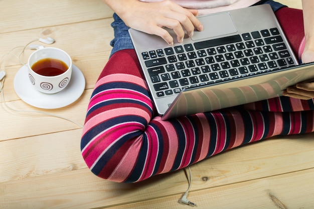 Teen girl sitting with a laptop