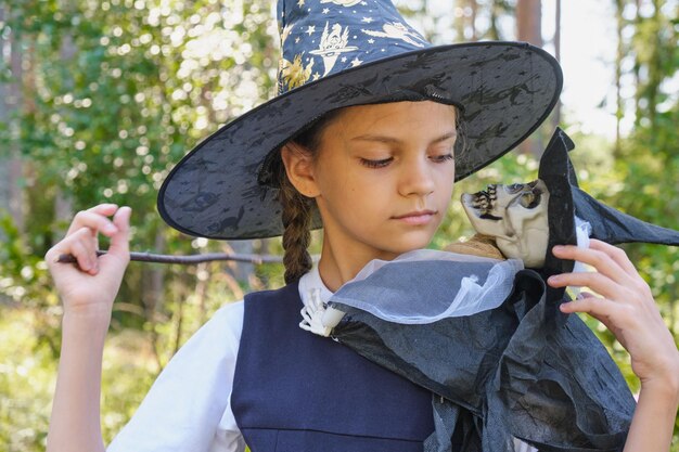 Teen girl in a witch costume in the park