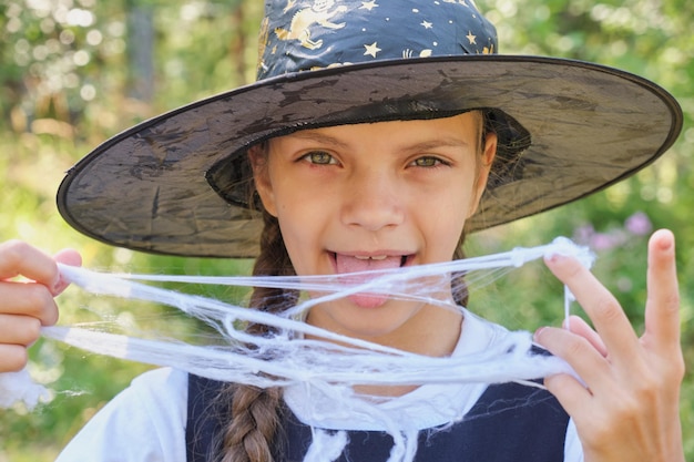 Teen girl in a witch costume in the park