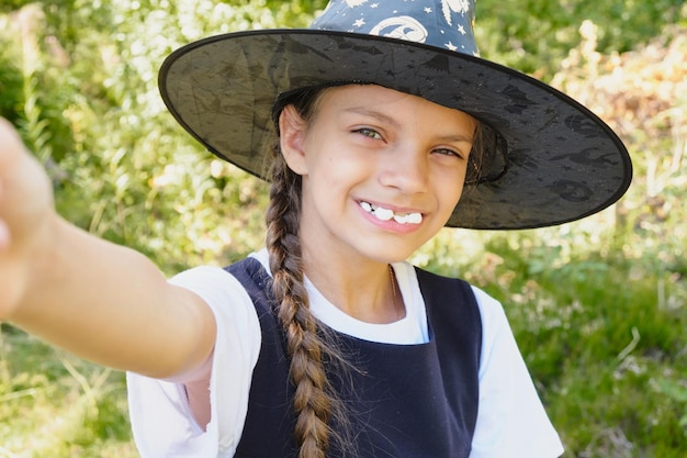 Teen girl in a witch costume in the park