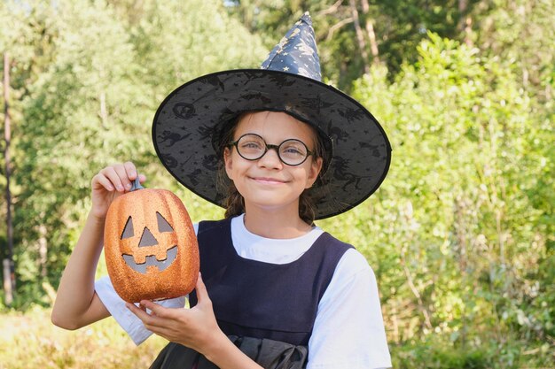 Teen girl in a witch costume in the park