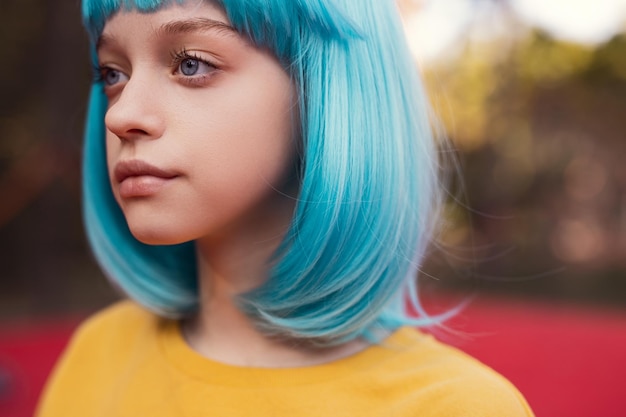 Teen girl with blue hair on playground