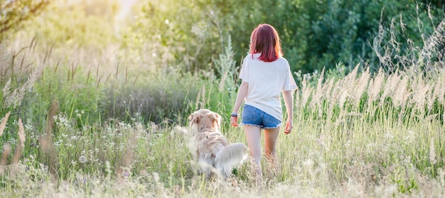 Teen girl with golden retriever dog