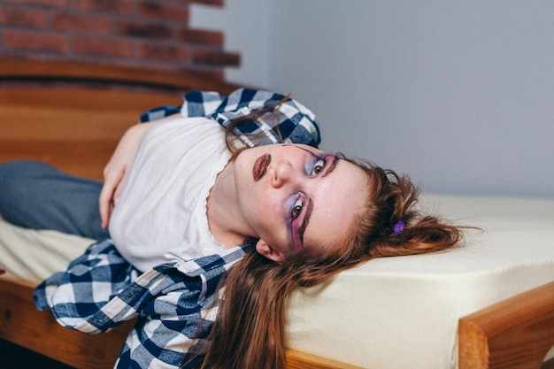 Teen girl with red hair and bright makeup generation z