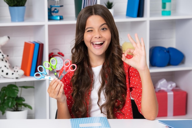 Photo teen girl with scissors diy ideas for children love and child art hobby concept excited face