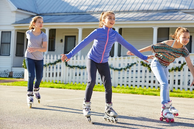 Teen girls group rolling skate in the street