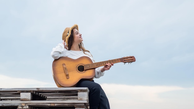 Teen hipster playing on guitar singer with acoustic guitar music and art musical shop happy girl enjoy the moment Have Fun on Celebration kid singing with guitar