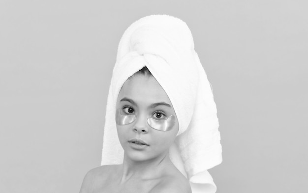 Teen kid in shower towel with golden patch