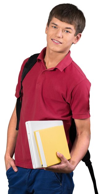 Teen male preppy holding laptop and school book