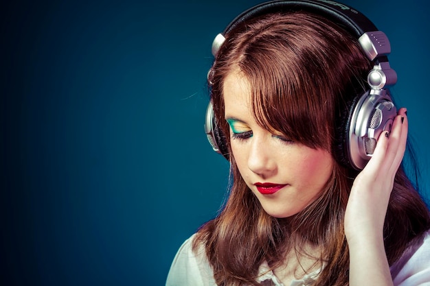 Teen, redhead teenager listening to rock music headphones