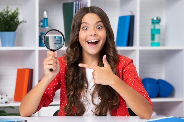 Teen school girl with magnifying glass knowledge Excited face cheerful emotions of teenager girl