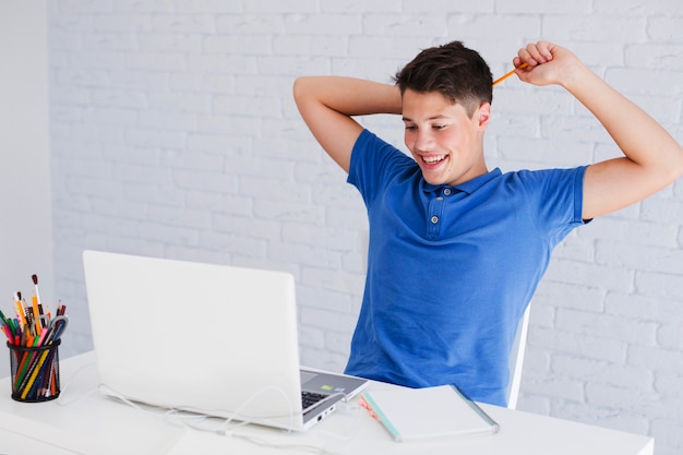 Teen scratching his head with pencil