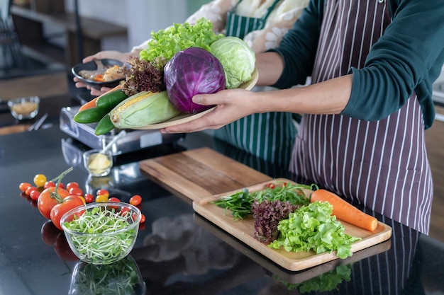 Teen showing shrimp and vegetables in the kitchen