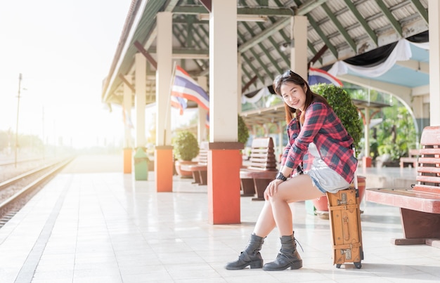 teen traveler sit on vintage bag