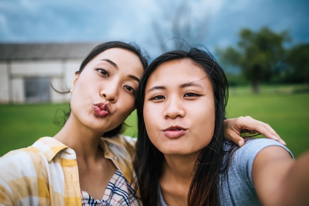 Teen women friendship looking at camera make selfie