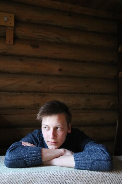 Teenage boy looking away at home