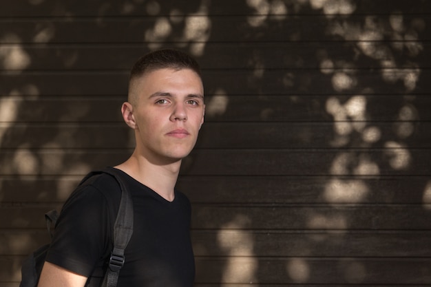 Teenage boy on the street with a bag