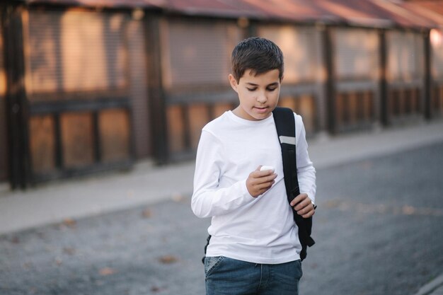 Teenage boy use wireless headphones for listening music